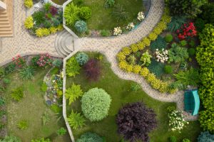 Aerial view of a well-manicured garden with winding pathways and assorted plants.