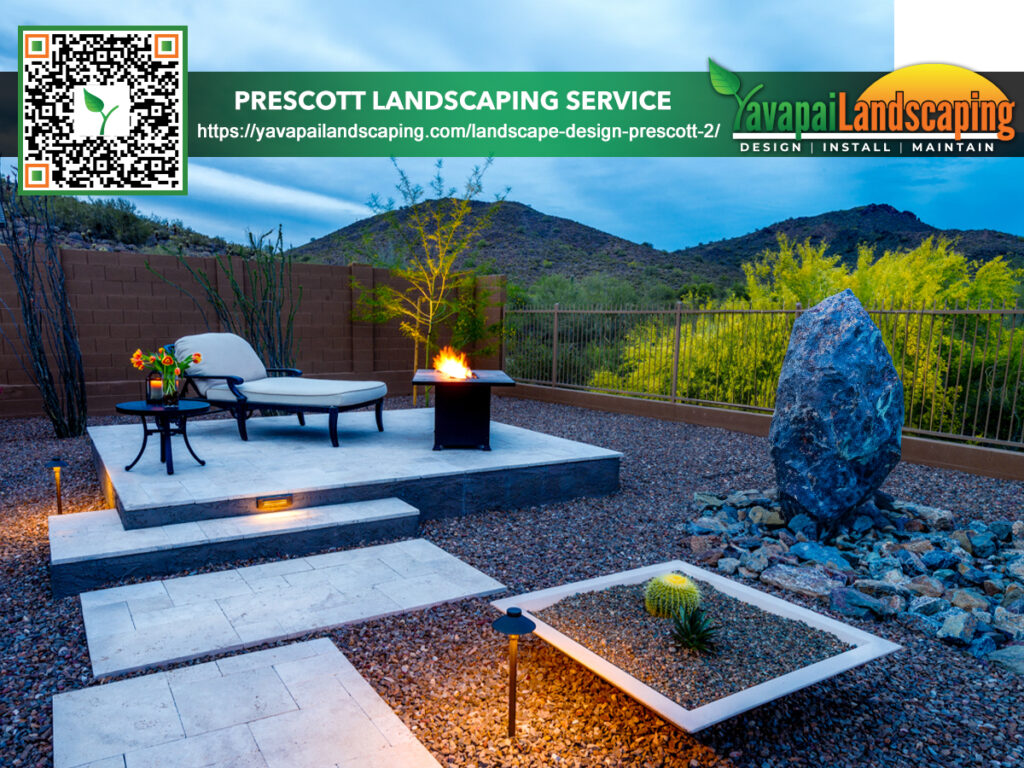 Modern backyard landscaping with stylish outdoor furniture, a fire feature, and decorative stones set against a backdrop of mountains at dusk.