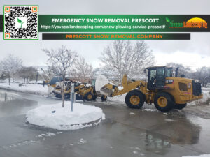 A snow removal service in action, with a yellow wheel loader clearing snow, depicting winter maintenance by a prescott snow removal company.