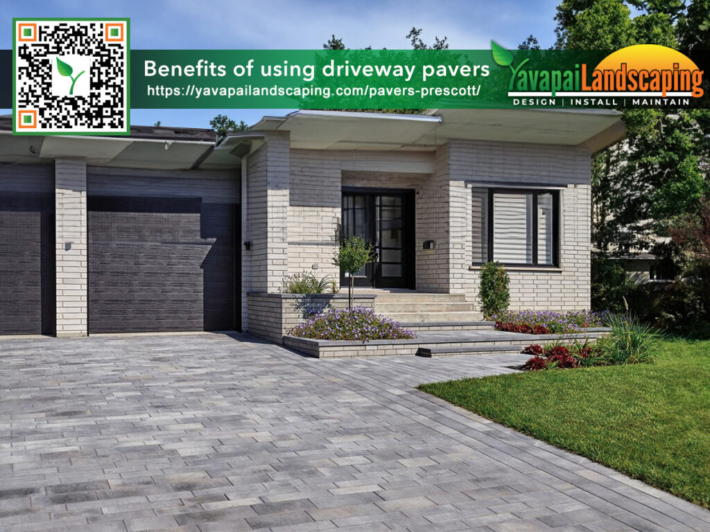 Modern home with a neatly installed paver driveway and landscaped garden, featuring the promotional information of yavapai landscaping.