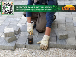 A professional landscaper installs interlocking pavers for a new patio, demonstrating expert craftsmanship in hardscaping.