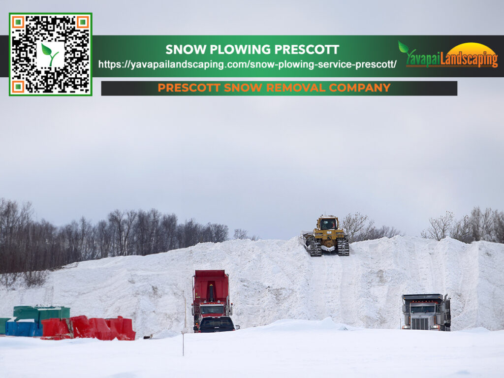 Snow removal operations in action, with heavy machinery managing a large pile of snow, under the promotional banner of prescott snow removal company.