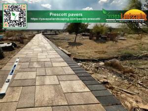 A promotional image for yavapai landscaping featuring a neatly constructed walkway made of square pavers leading through a rugged landscape, including a website url and qr code for more information.