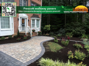 Elegantly designed curved walkway featuring interlocking pavers leading to a classic red-brick house, surrounded by lush greenery and fresh mulch, enhanced by flowering plants, with the logo and qr code for yavapai landscaping, a company specializing in landscape design, installation, and maintenance.