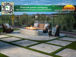 An inviting outdoor patio setup by Prescott AZ Paver Company featuring a warm fire pit, elegant paving stones in a grid pattern with grass insets, comfortable seating, and a serene landscaped background, perfect for