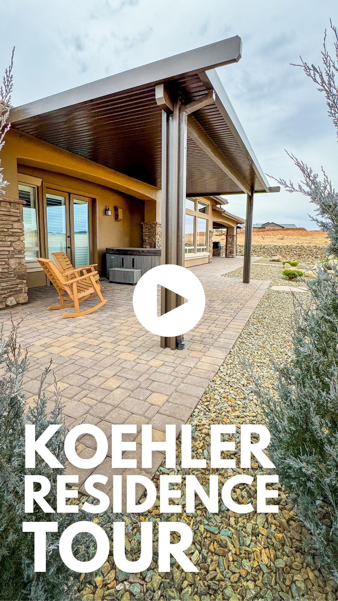 Koehler Residence outdoor living space featuring a stone patio, wooden rocking chair, and landscaped stones, promoting Yavapai Landscaping's design expertise.