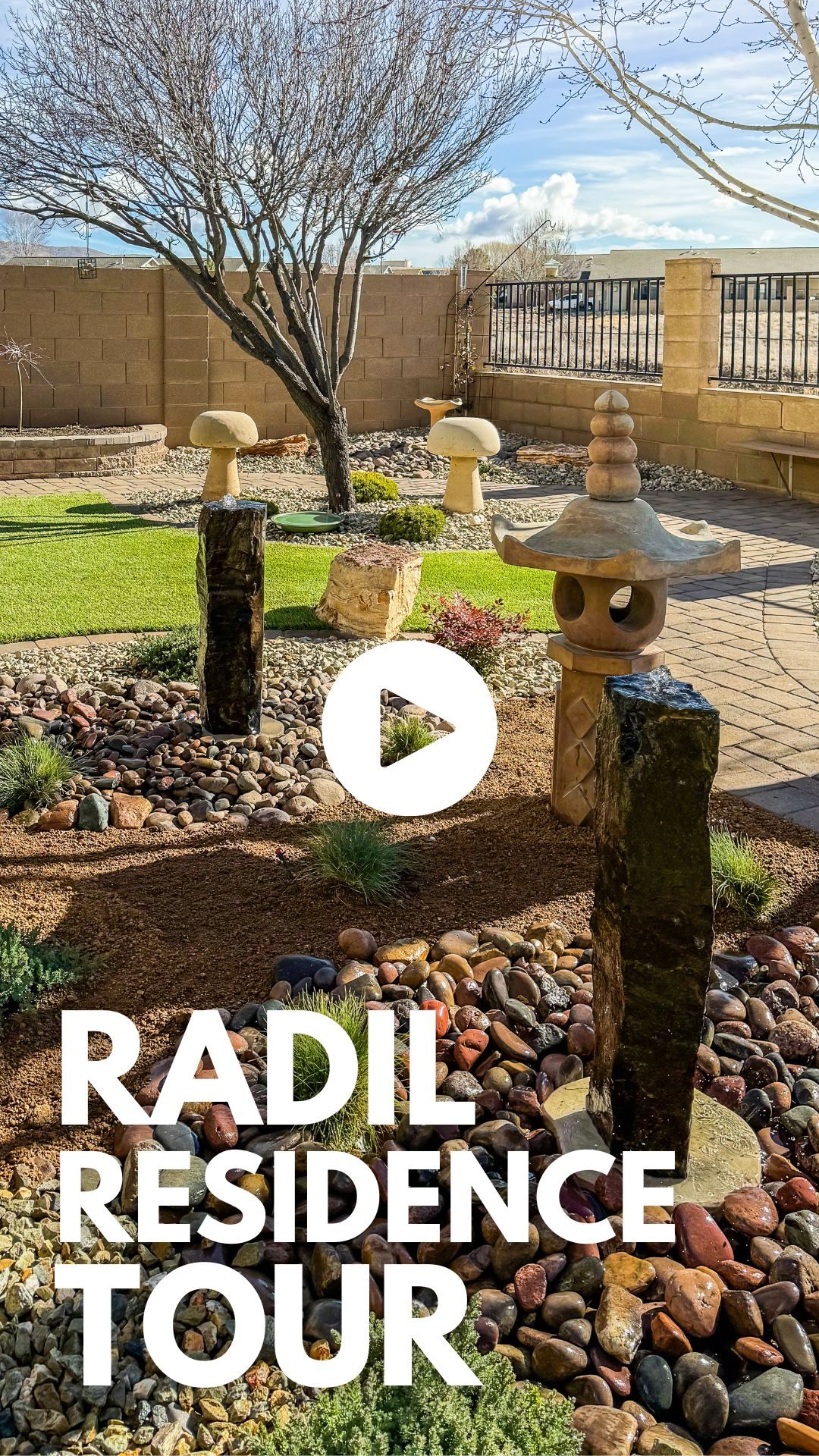 A zen garden with expertly maintained trees, stone sculptures, smooth colorful rocks, and a tree. Text reads "Radil Residence Tour" with a play button icon in the center.